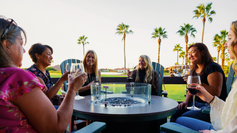 Ladies having sunset drinks at Divots Bar and Grill fire pit