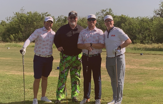 A group of tournament golfers gathered on the green at South Padre Island Golf Club.